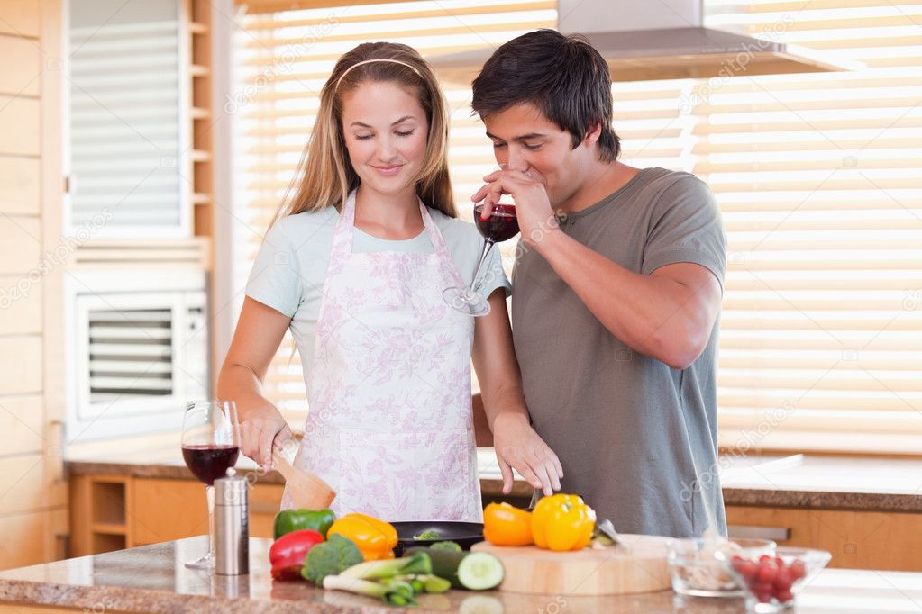 depositphotos 11207121 stock photo young couple cooking dinner while